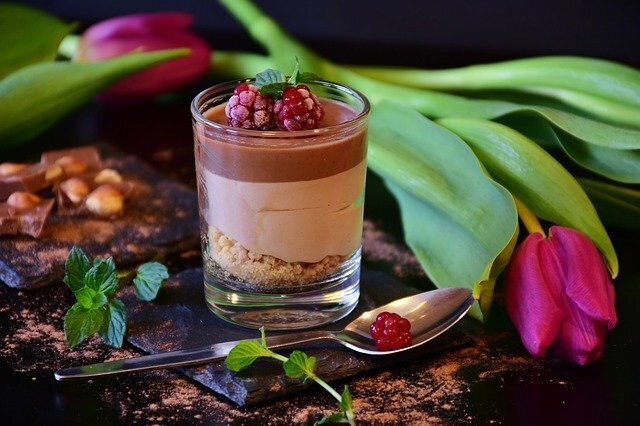 cup of nougat with a spoon and a raspberry 