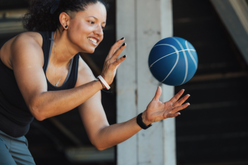 Woman trying to catch a ball. Athlete training; Getty images