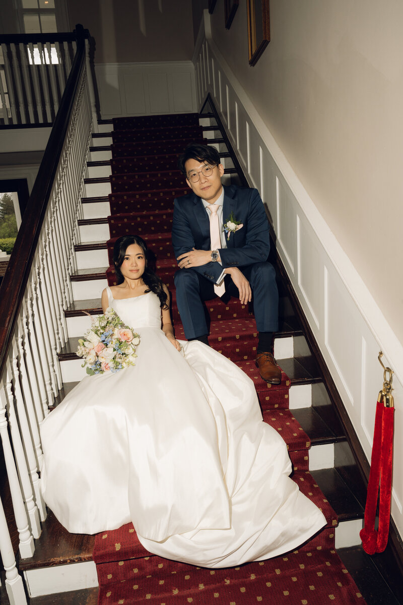 editorial style couple posed on the stairs at Virginia wedding reception 