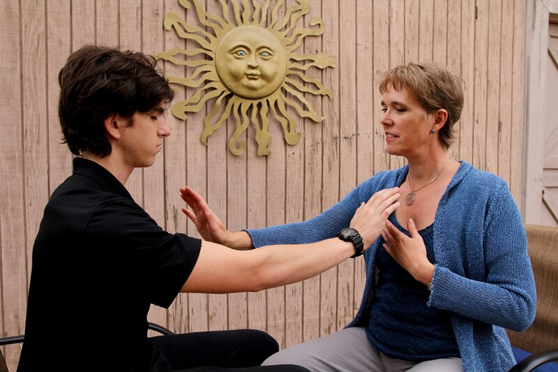 Energy healer and founder of Nurses Healing Nurses, Lori Harger, practicing Heart-Energy Healing with a client