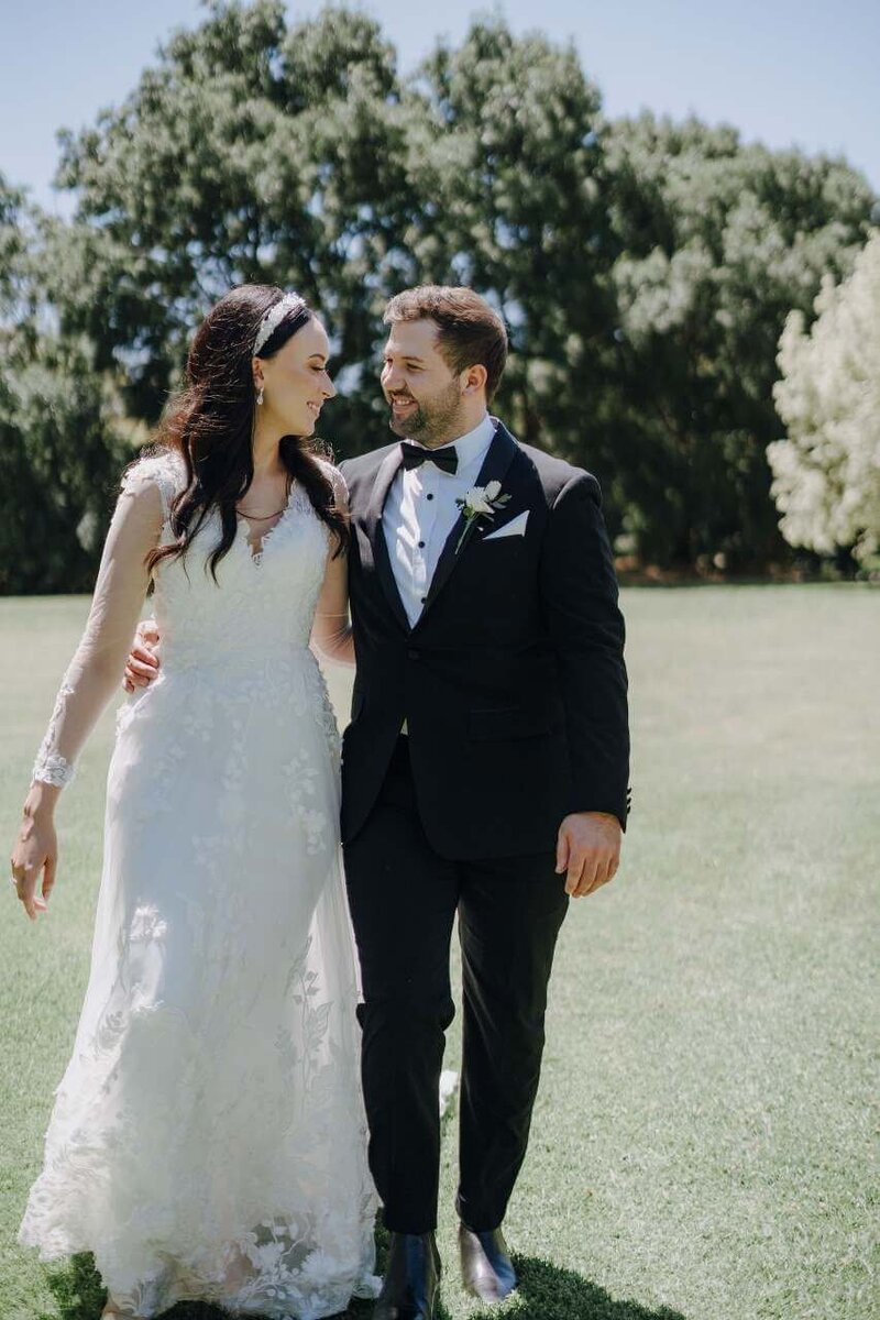 Bride and groom hugging each other.