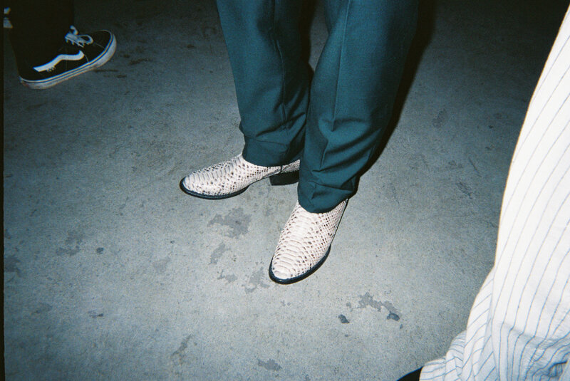 Tattooed couple sharing a candid moment during their alternative wedding in Springfield, MO, photographed by Chelsea Stanford