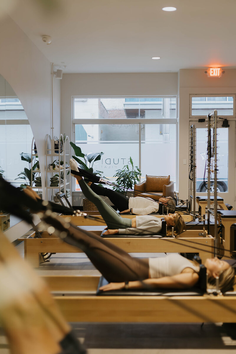 Pilates class, feet in straps 