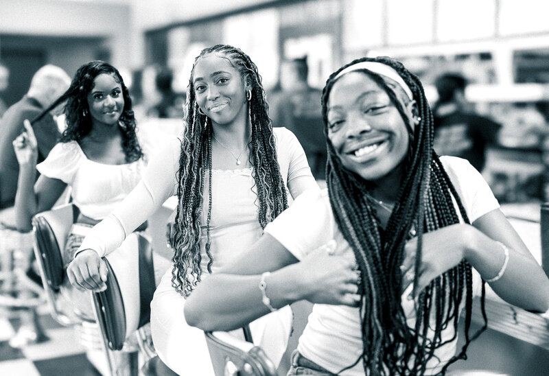 a high school senior sitting with her friends in a retro diner