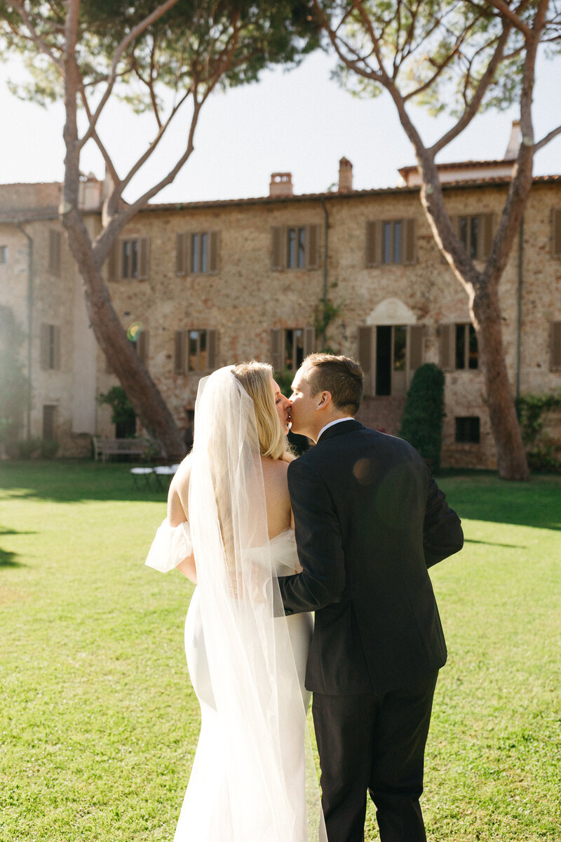 Couple Kiss as they walk to their Tuscan Villa