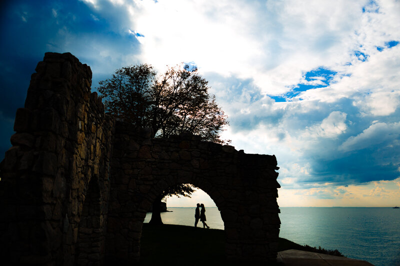 Silhouette of an engaged couple under a rock arch by Lake Erie and Catawba Island in Ohio