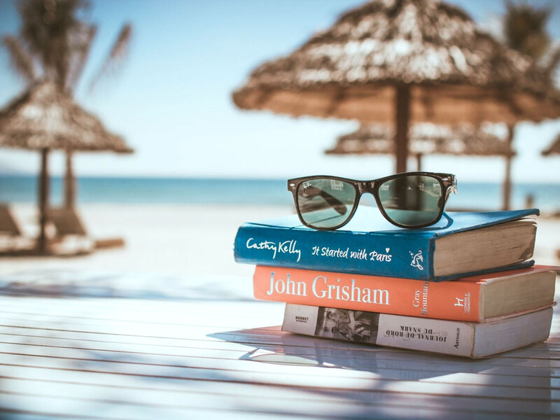relaxing on the beach with books and sunglasses