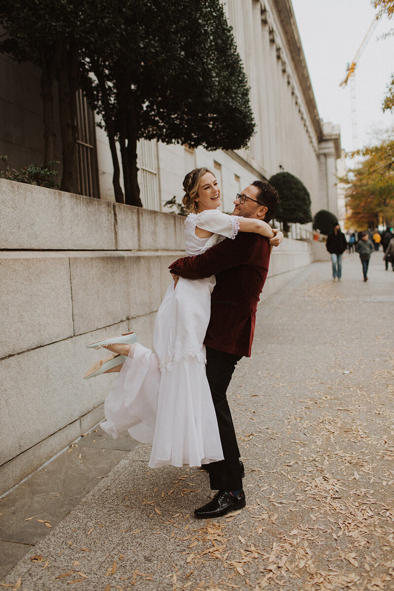 Groom Lifts Bride in DC Wedding
