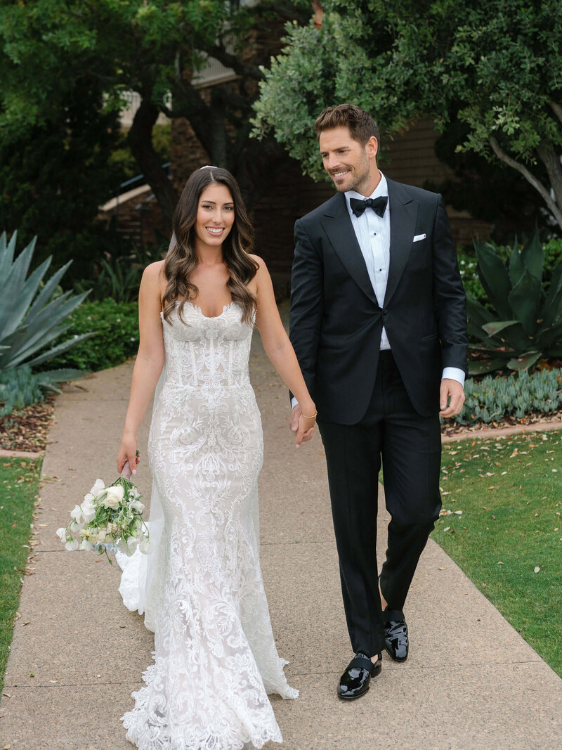 Bride and groom holding hands