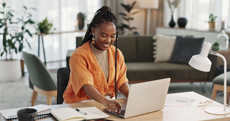 Woman using laptop for trademark registration