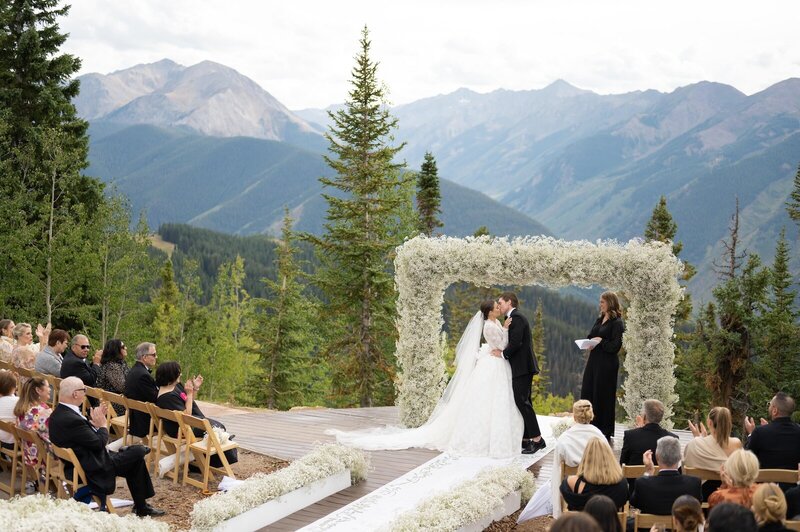 Wide shot of ceremony view at the Little Nell Sundeck during couples first kiss. 