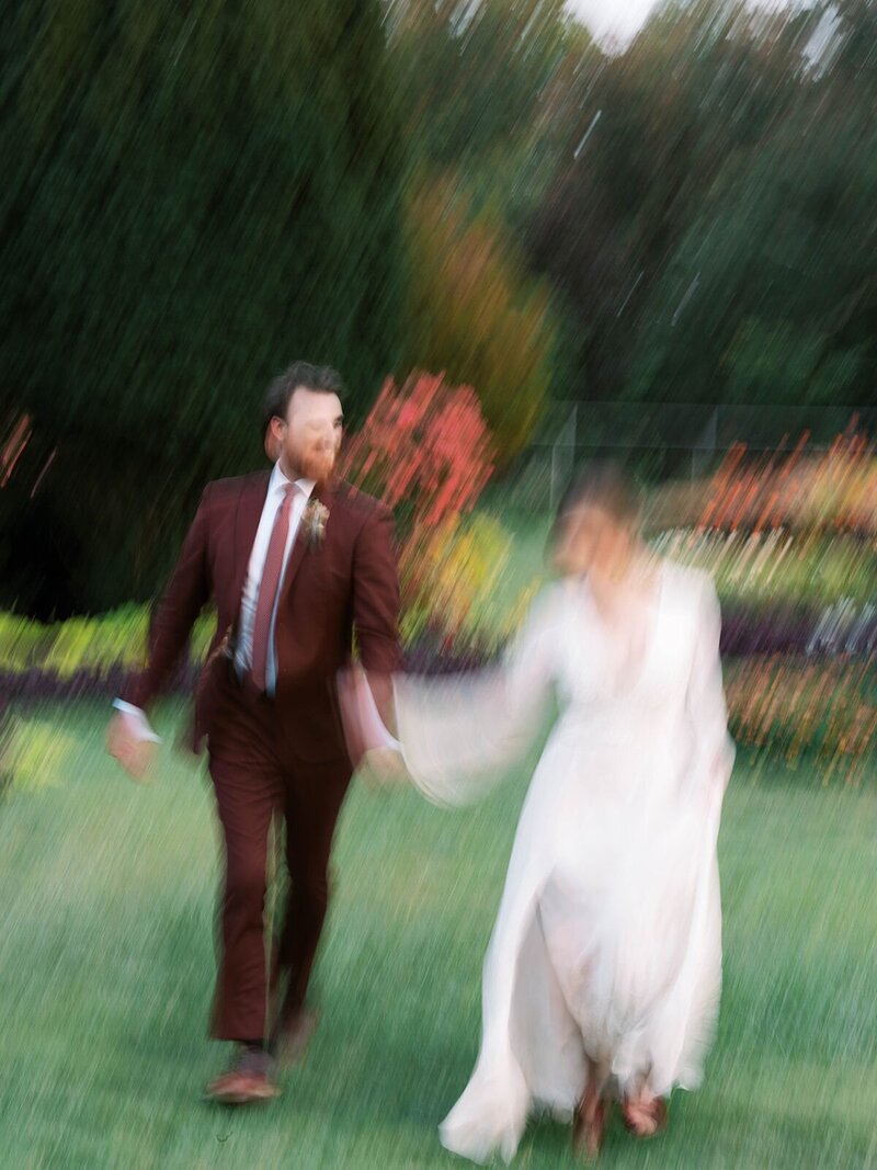 Motion photography of bride and groom holding hands at Rawlings Conservatory