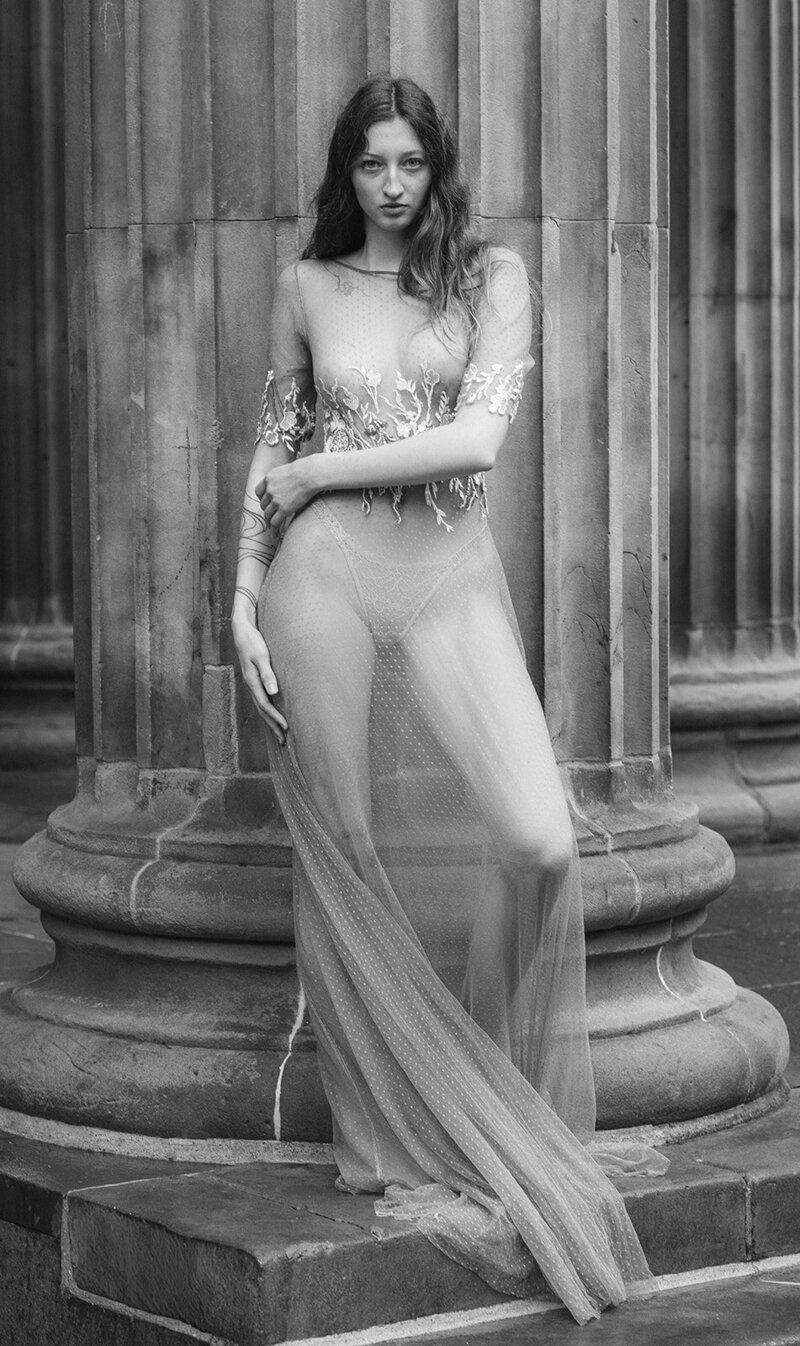 Americans getting married in a Scottish Castle. Bride and groom kissing under a veil 