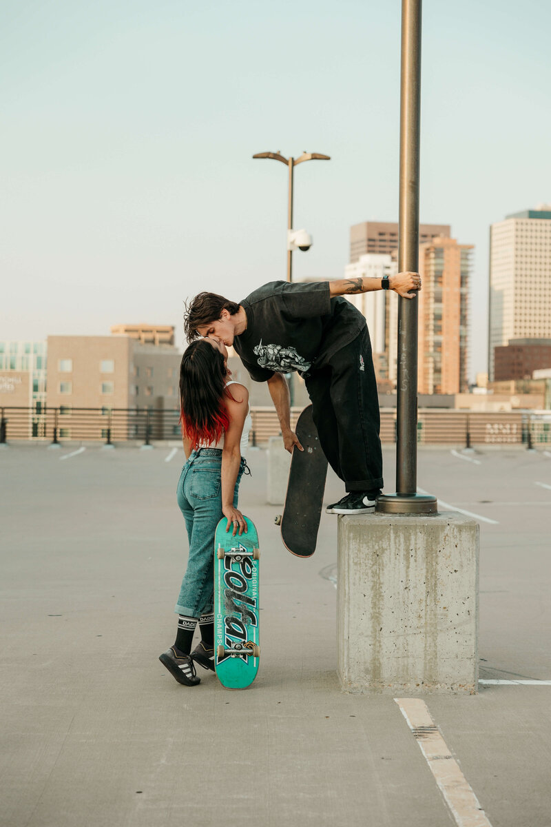 Skateboarder Kissing Girl in Parking Lot