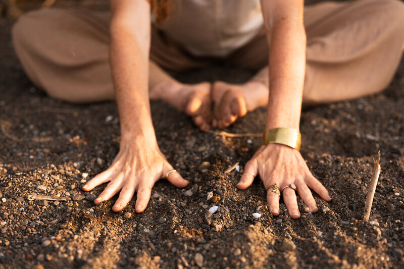 yoga teacher with palms flat on the earth