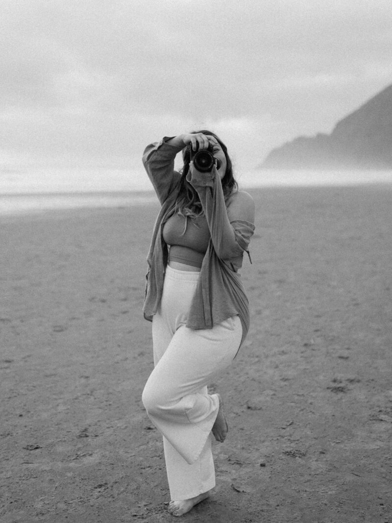 Picture of Erinn Ortiz holding up her camera on Manzinita Beach in Oregon