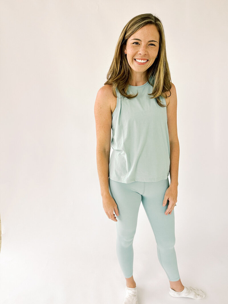 zoom out of woman wearing longer length tank