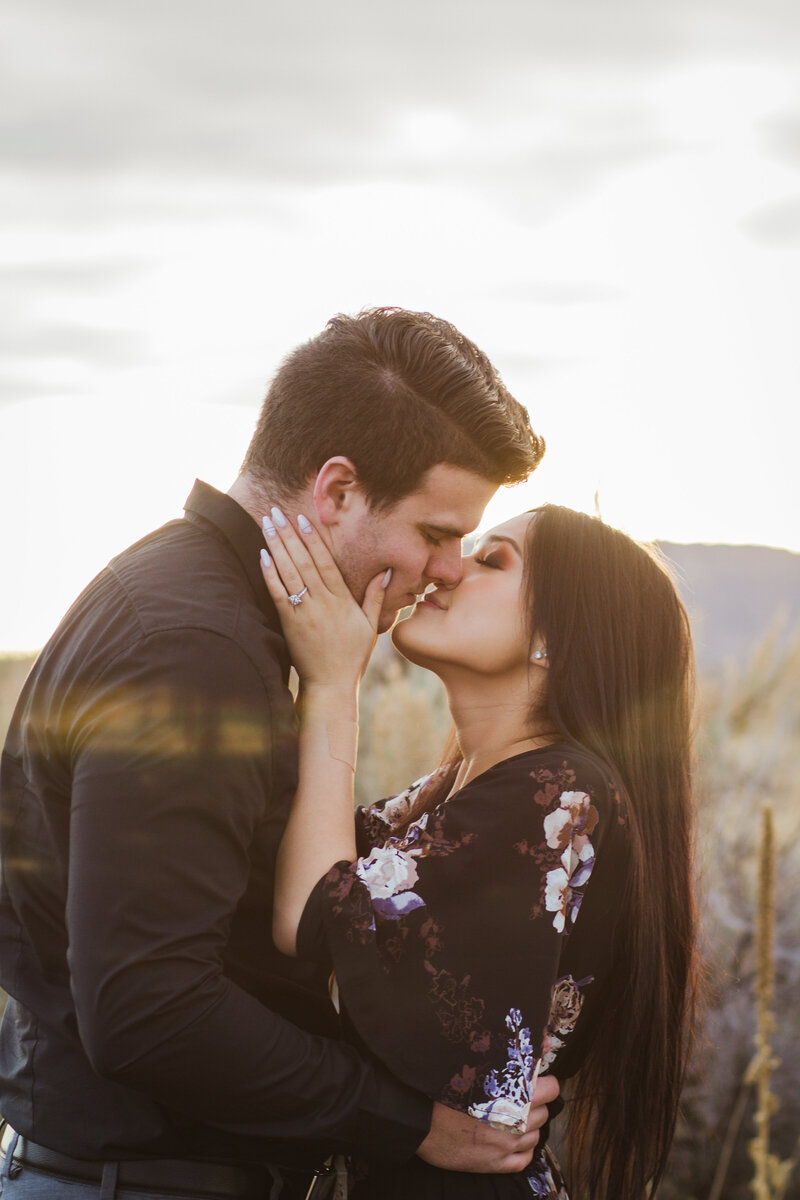 man and woman kissing during outdoor engagement session