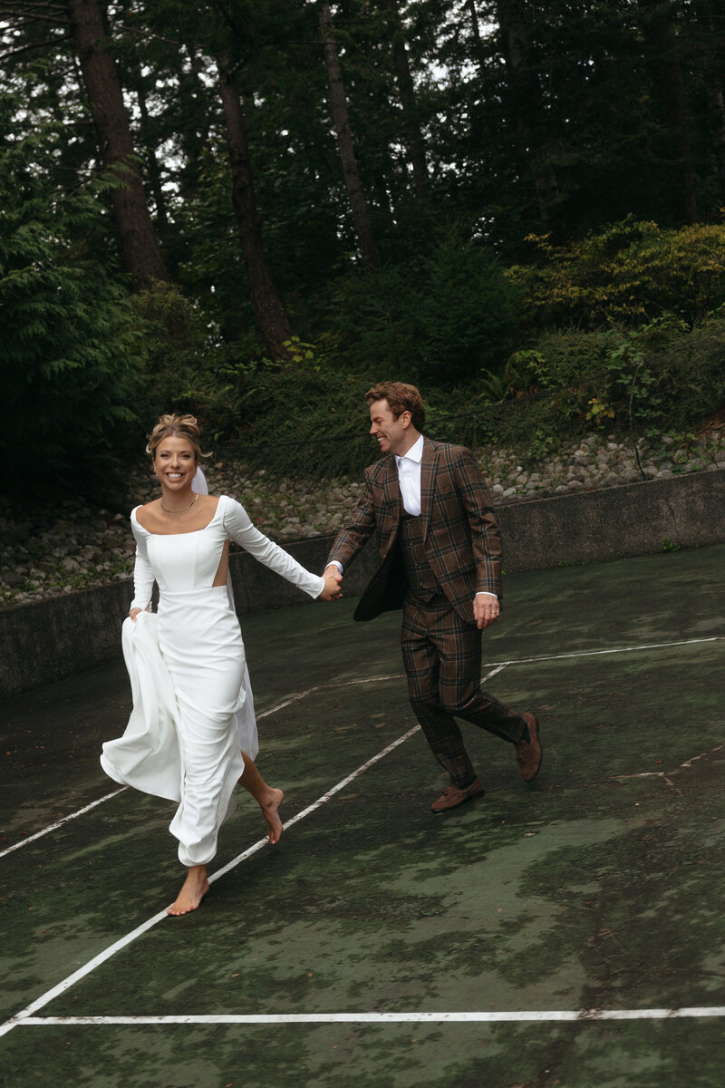 Newlyweds Kris and Tim sharing a joyful moment during their Vancouver Island wedding, captured by Rae Terrillon.