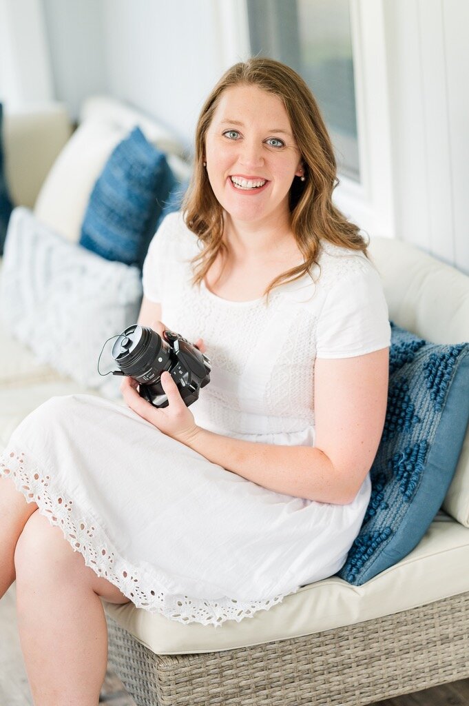 Best Central Massachusetts Newborn photographer Taryn Pratt sitting with her camera