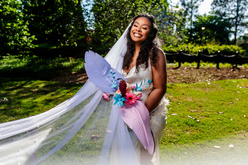 A radiant Black bride holds a stunning colorful bouquet designed by Popout Decor, perfectly complementing her elopement. A celebration of beauty, love, and bold colors in one frame.