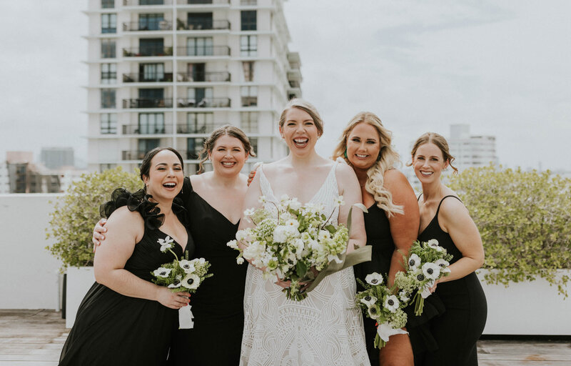 Jessica surrounded by her bridesmaids holding their incredible bouquets.