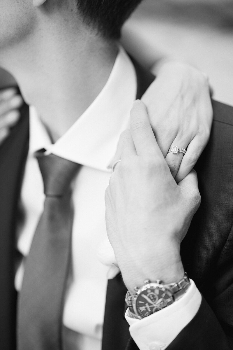 detail photo of the bride and groom holding hands during their portrait session on their wedding day