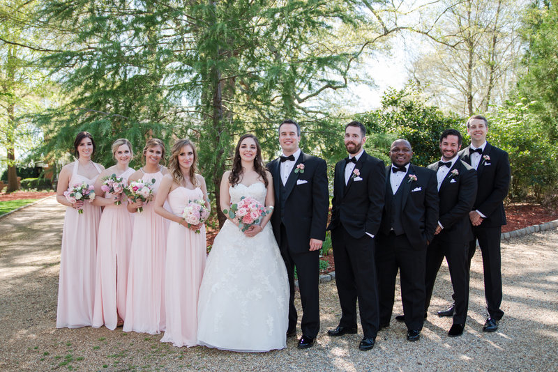 Rsowell bridal party in pink dresses and black tuxedos