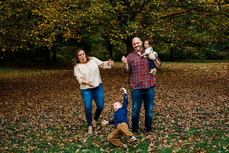 A child wipes out on fall leaves.