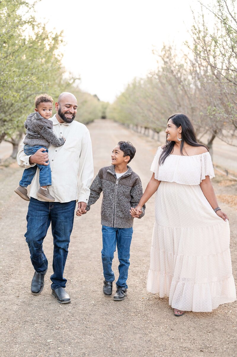 Family walking during family photos with Gia Chong Stockton Photographer