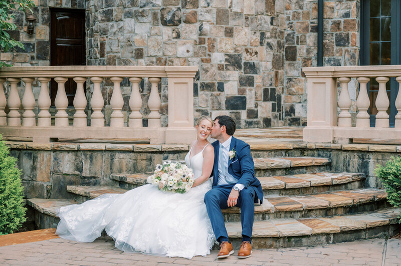 bride and groom sit on the steps of Atlanta estate