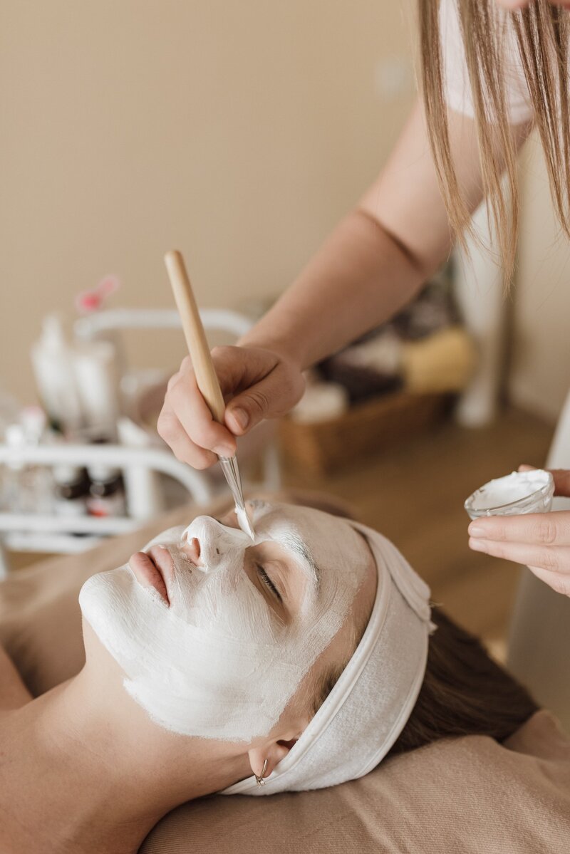 Woman is very relaxed and getting a calming facial.