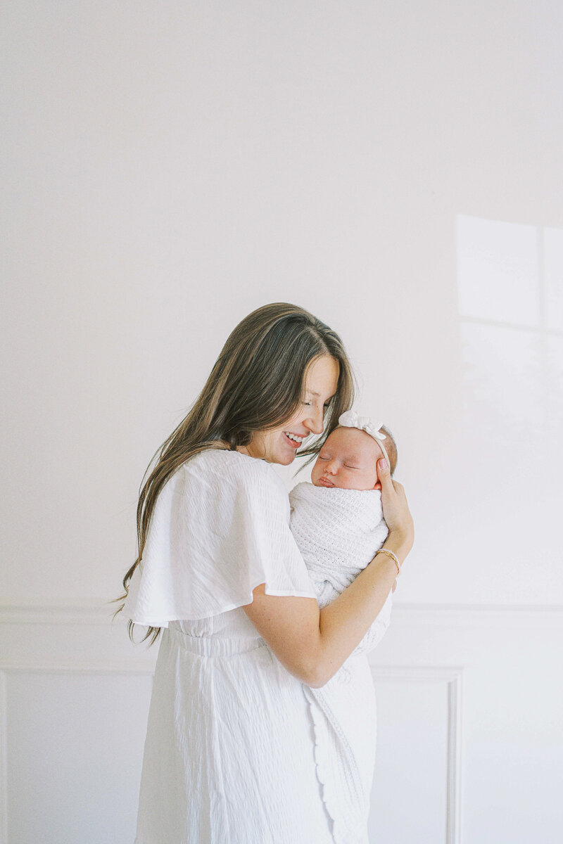 a mom smiling at her baby during a studio session