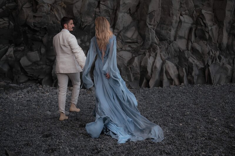 Windswept and wild, a couple stands together on Iceland’s black sand coast.