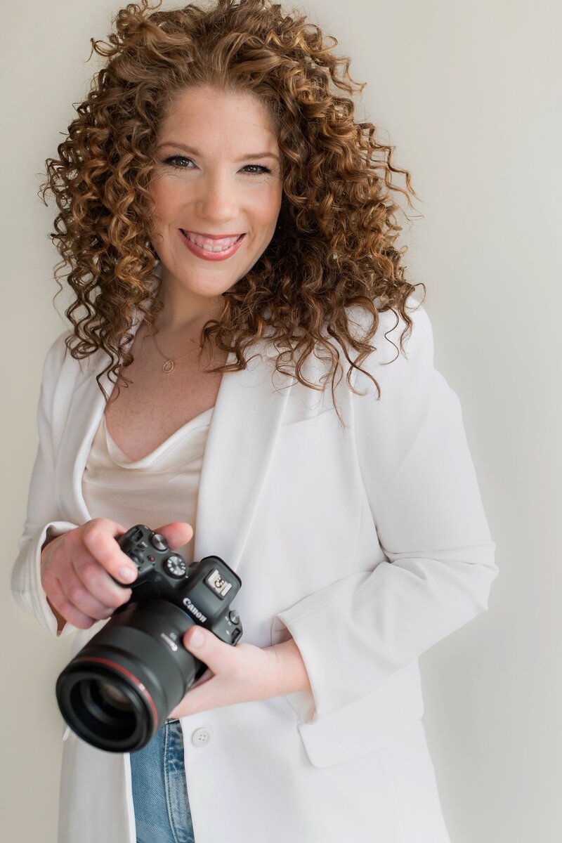 Deborah Zoe, Boston wedding photographer, holding camera