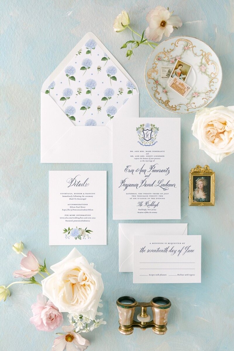 Custom floral wedding invitations with rink box and floral decor