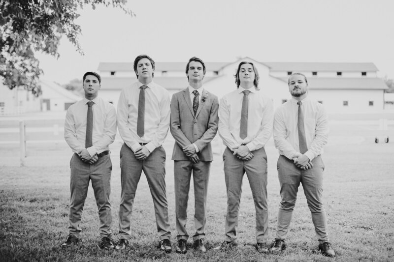groom standing with with groomsmen on wedding day