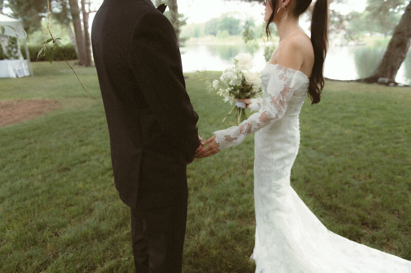 A bride and groom holding hands documented by a Sudbury Documentary Photographer