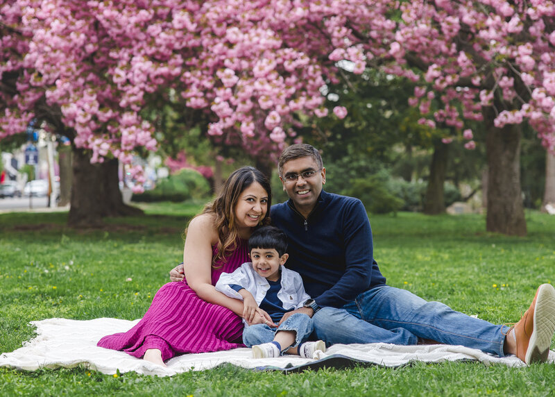 Effortless lifestyle photo of family hugging and smiling at an Essex County, New Jersey park.