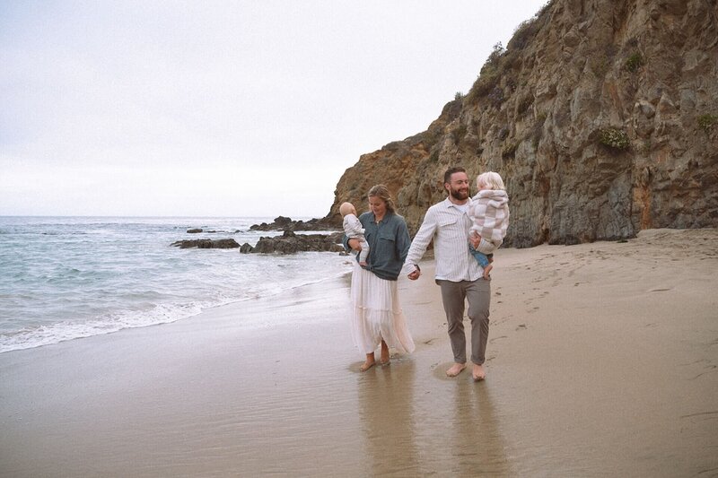 family of four walking at crescent bay in laguna beach