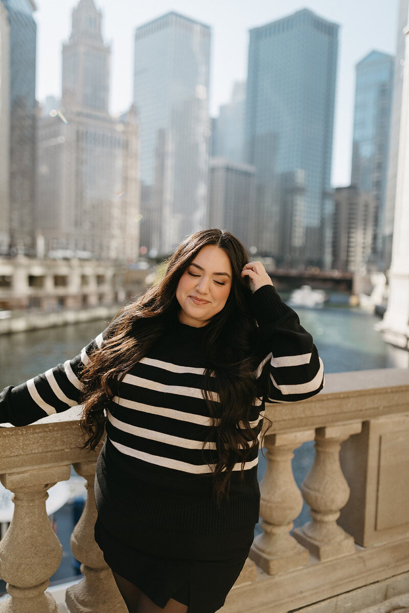 Makeup Artist posing in front of the Chicago Riverwalk and city skyline in Chicago, Illinois