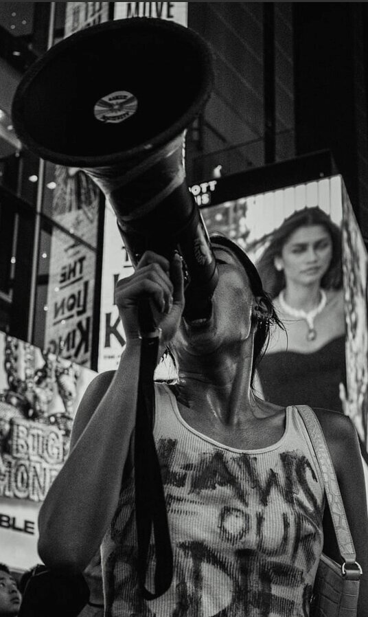 Image of personal fitness trainer sitting on road
