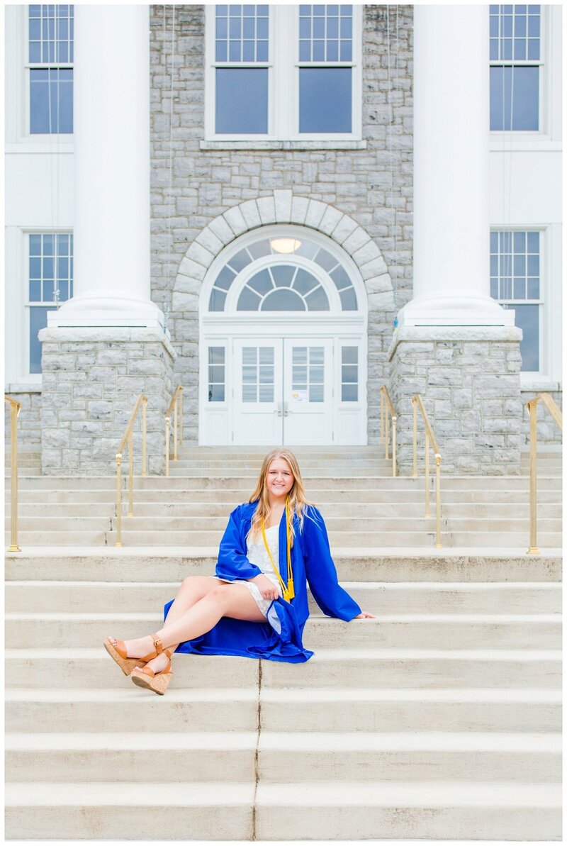 JMU college senior posing with the iconic JMU campus backdrop, capturing achievement and pride