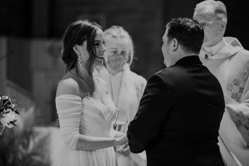 A wedding couple standing up at the altar