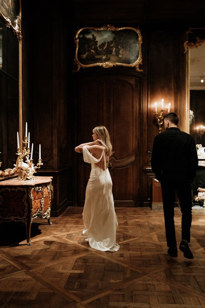 Washington DC portrait gallery where the bride is fixing herself up and the groom is admiring her