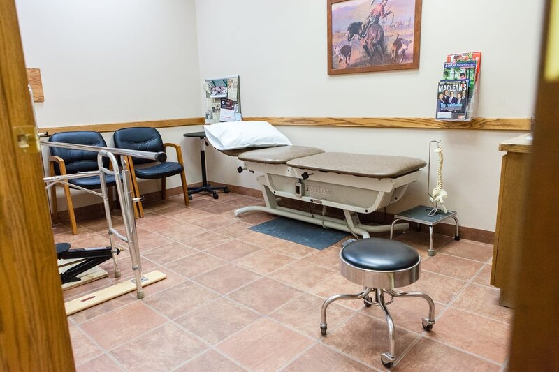 A room in Lethbridge Orthotics' office in Alberta, Canada equipped with clinic beds and seats.