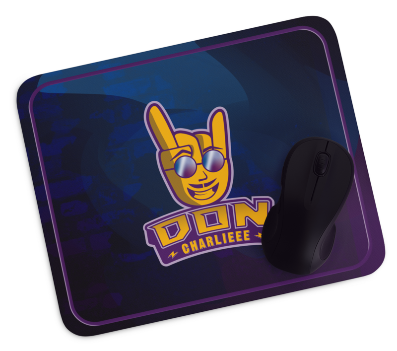 Mousepad of Don Charlieee rockin' hand mascot, sitting on top of black wooden table.