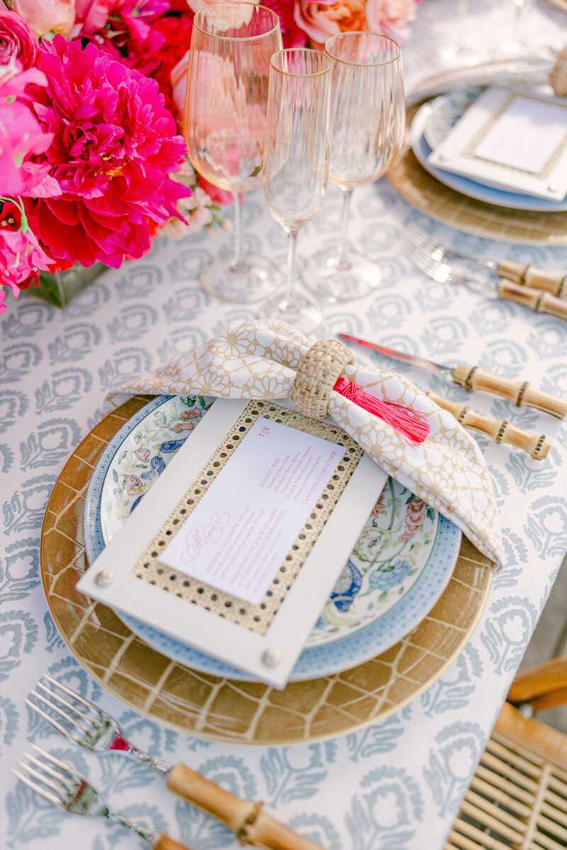 Wedding table with dinnerwares that has menu calligraphy