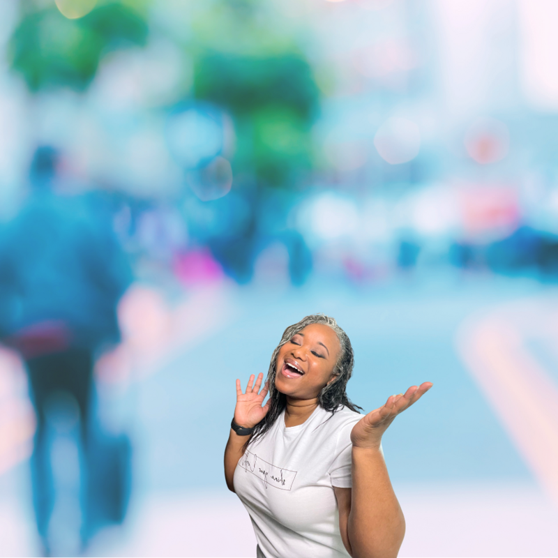 Letitia Hopkins smiling with eyes closed and hands raised, embodying joy, self-love, and Main Character Energy as Founder of Encourage Over Everything, empowering women to fully step into their confidence and purpose.