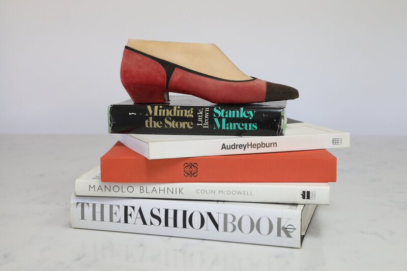 Stack of fashion books and shoe lathe